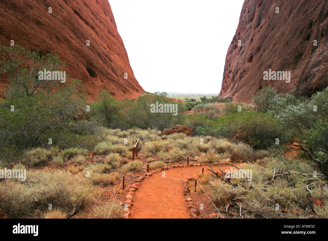 The main hiking path cuts through the giant red sandstone domes of the Olgas northern territory Australia Stock Photo
