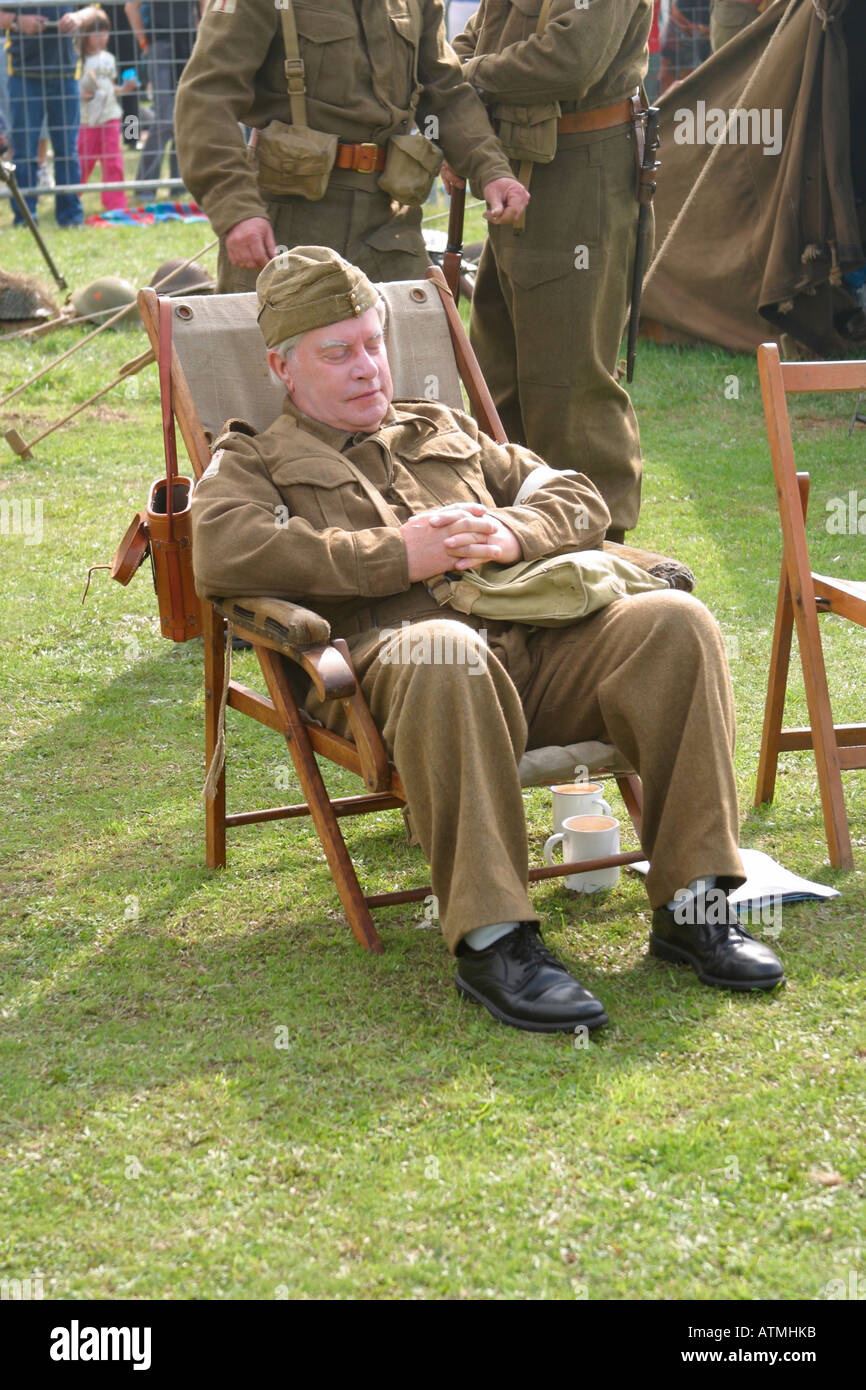 Dad's Army Private Godfrey lookalike asleep on chair at Shoreham Airshow, Sussex, England Stock Photo