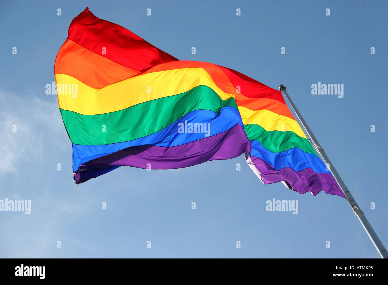 Rainbow flag flying in the wind Stock Photo