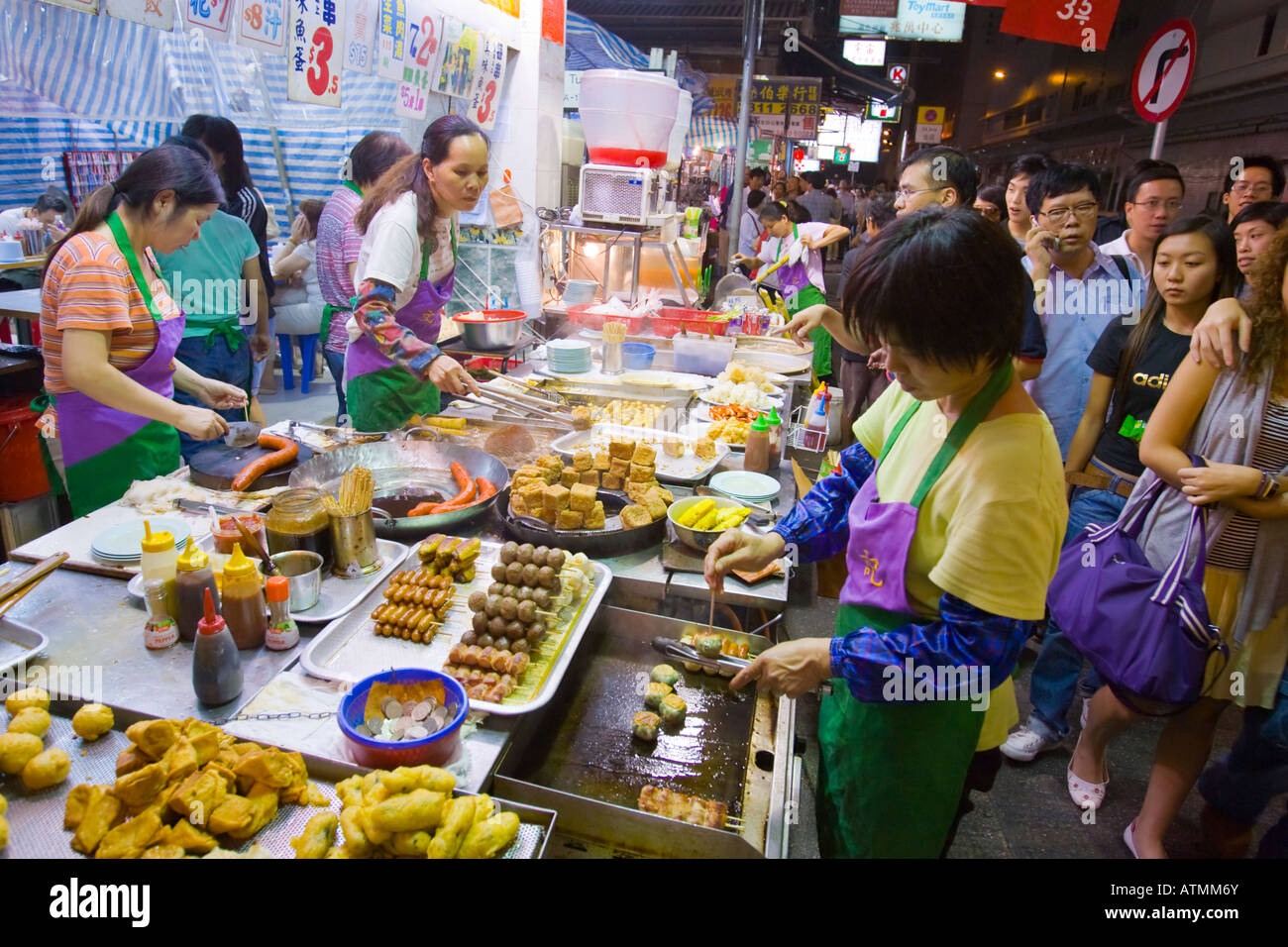 HONG KONG CHINA Food vendor on sidewalk at night in busy Mong Kok