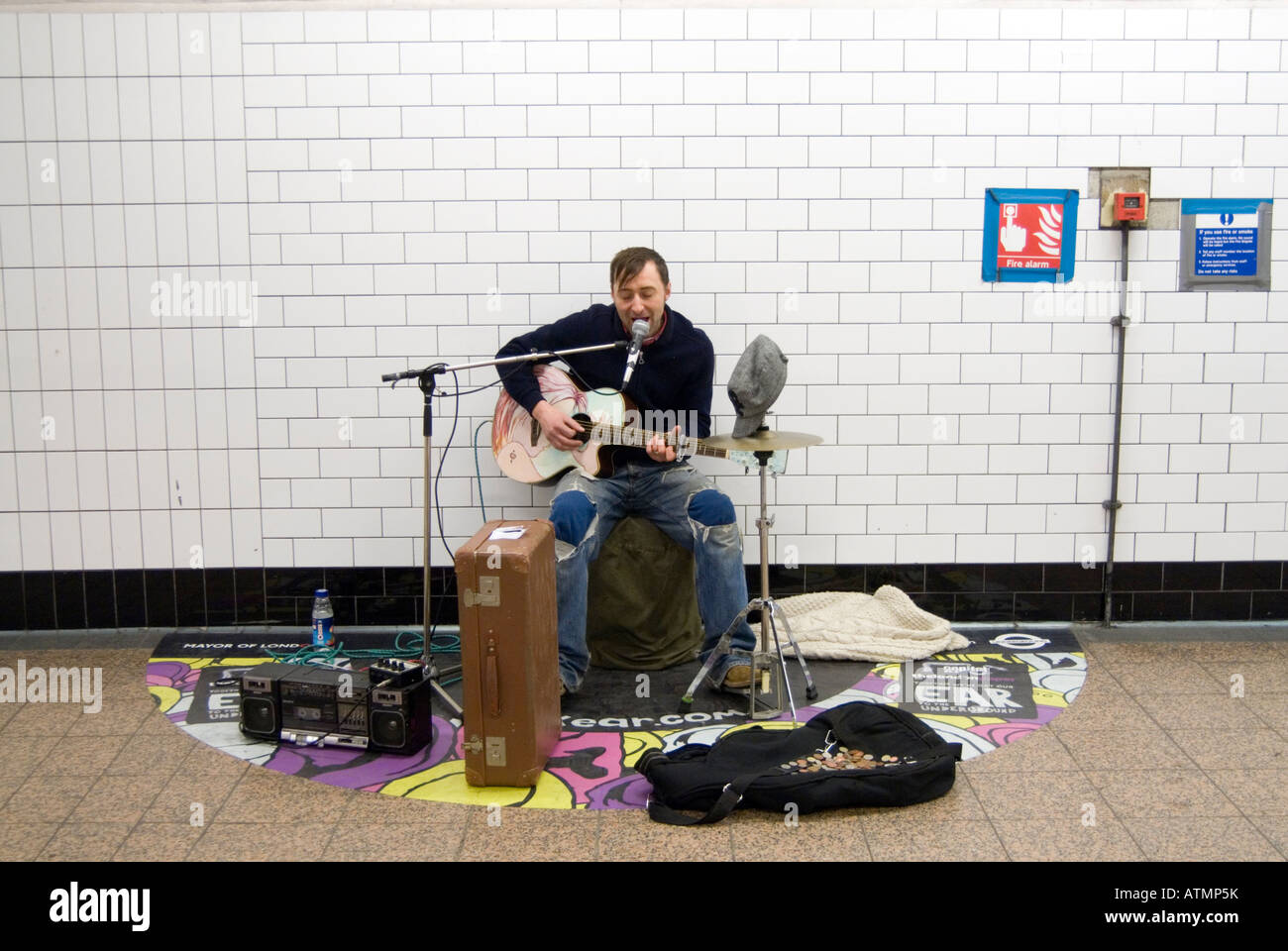 Busker playing at a London Underground station London England UK Stock