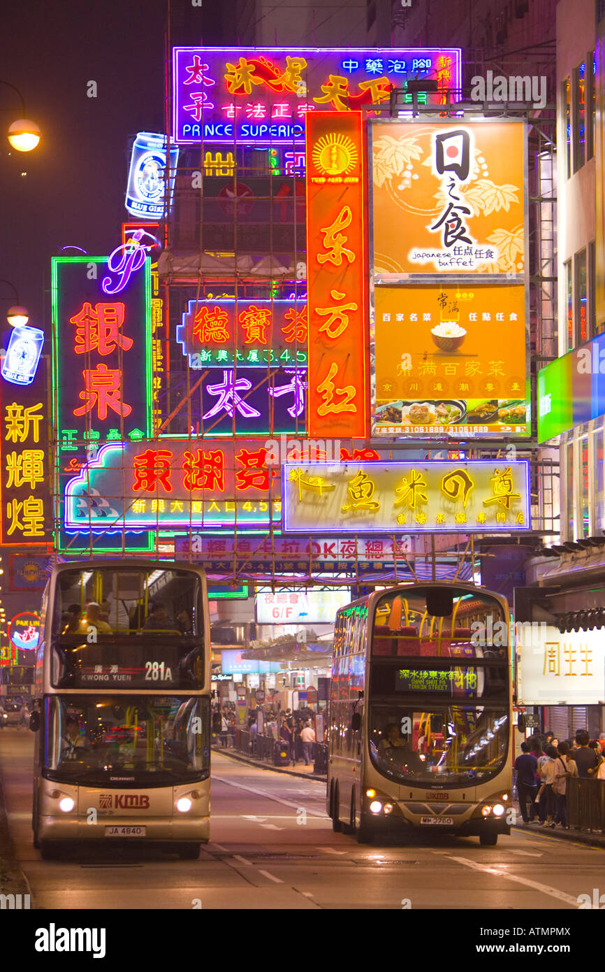 HONG KONG CHINA Colorful neon signs and bus traffic at night in Kowloon Stock Photo