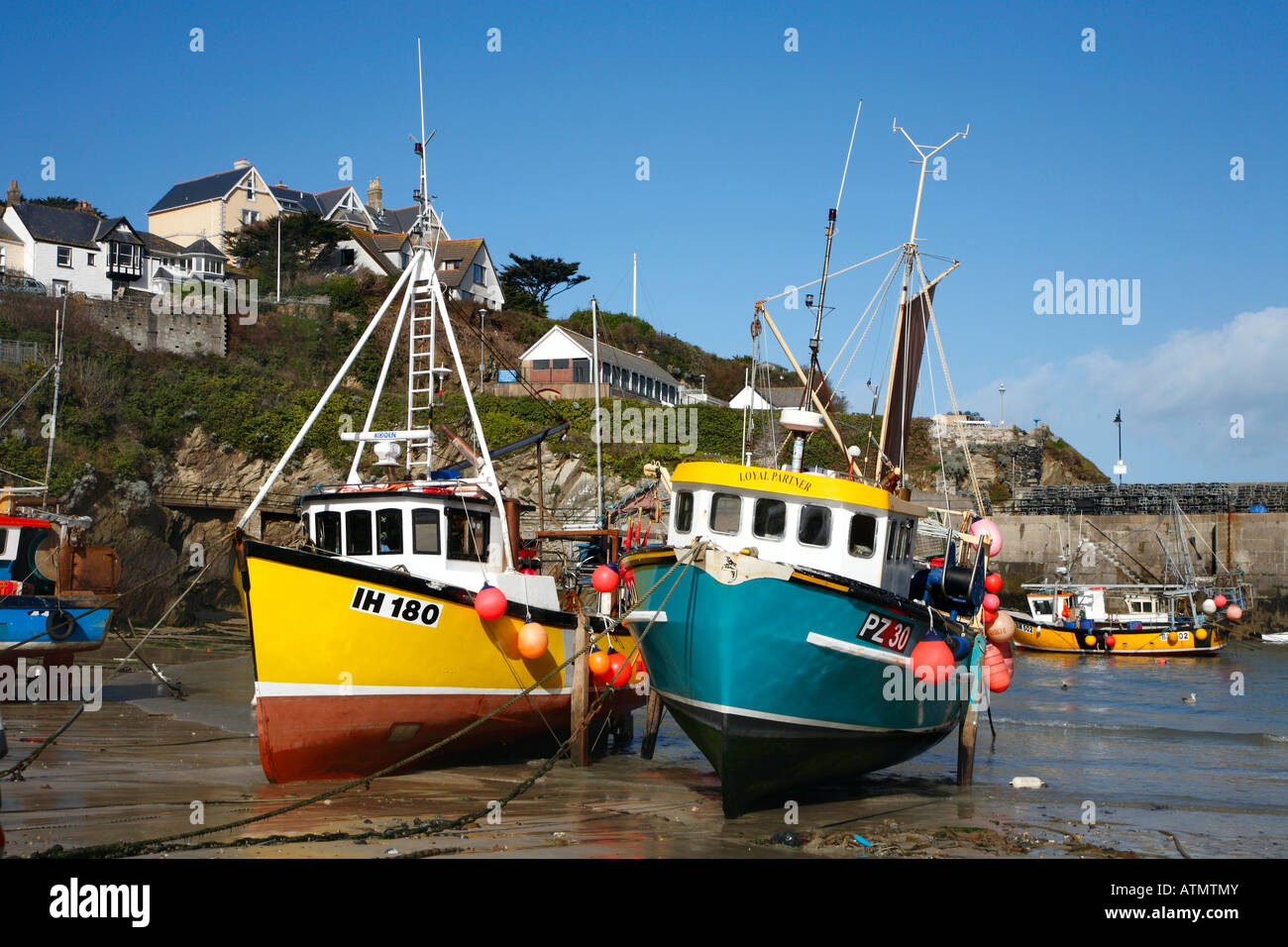 Colourful fishing boats at low tide in Newquay harbour, Cornwall UK Stock Photo Alamy