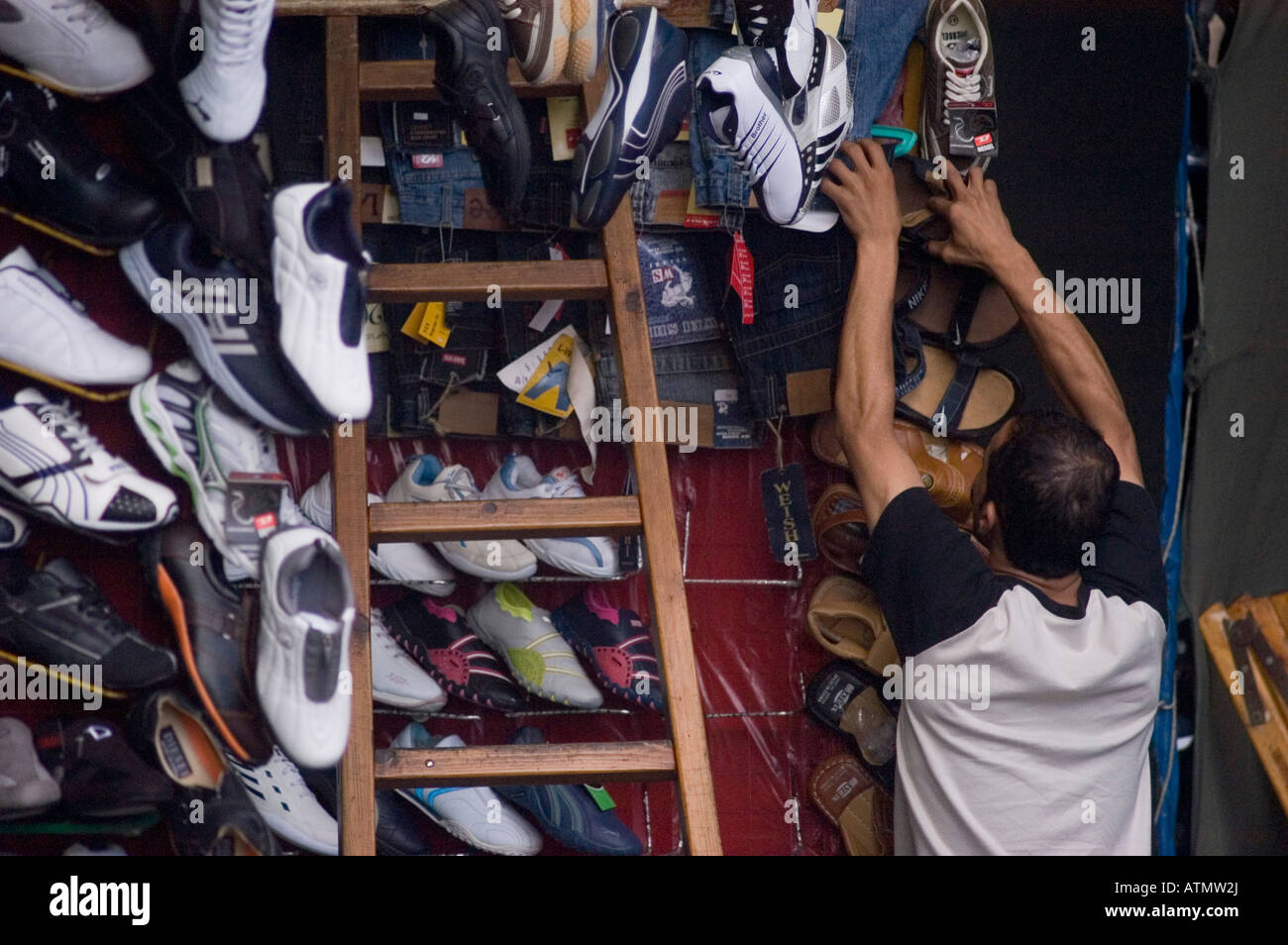 Man selling shoes in small shop in Alexandria Egypt Stock Photo Alamy