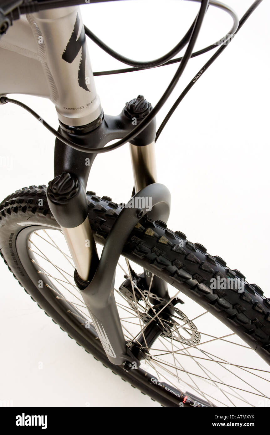 Closeup of the front forks and tyre of a mountain bike seen against a