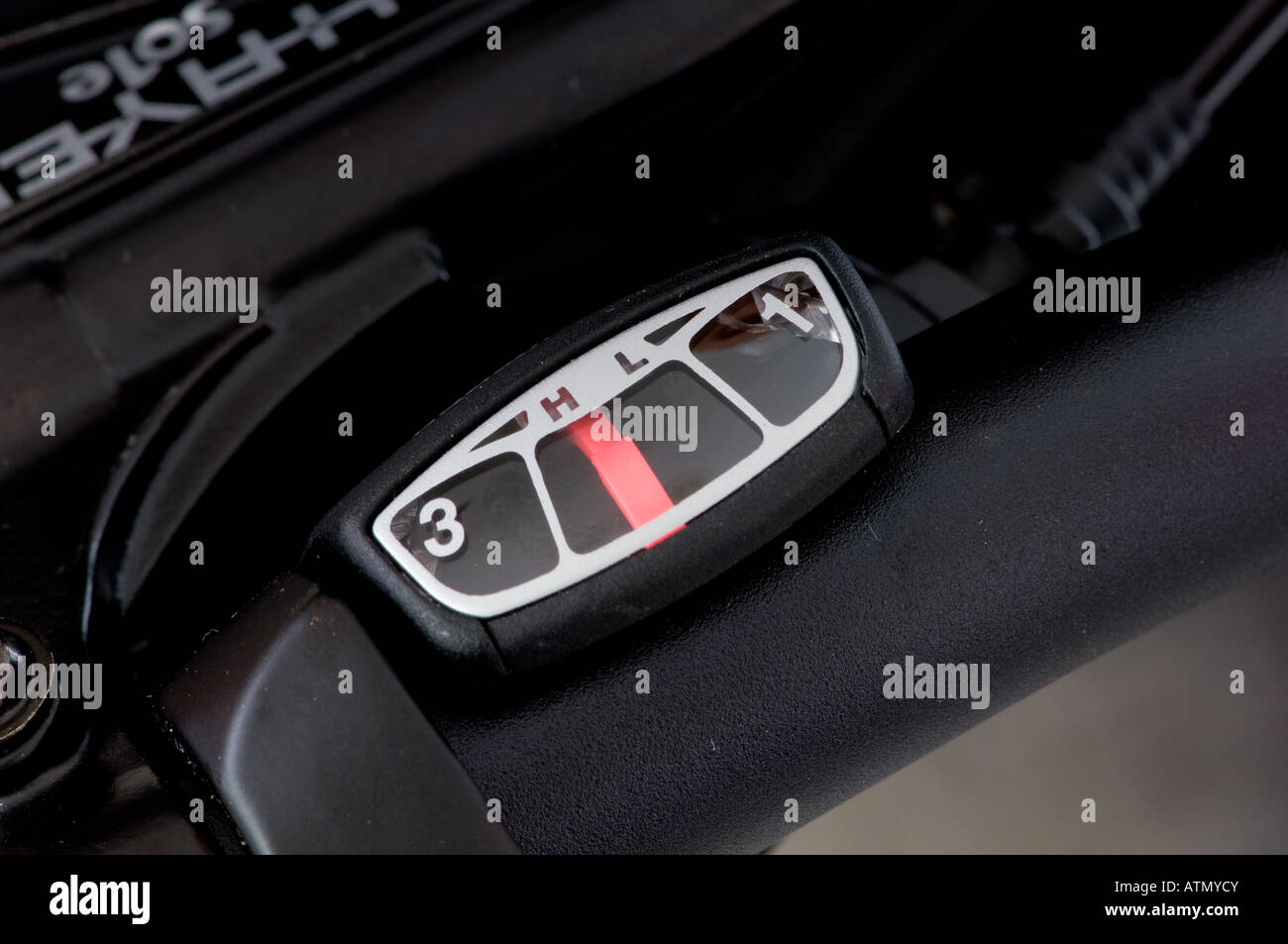 Closeup of a gear shifter on the black handlebars of a mountain bike