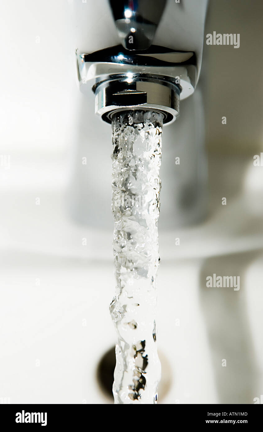 running tap into sink Stock Photo Alamy