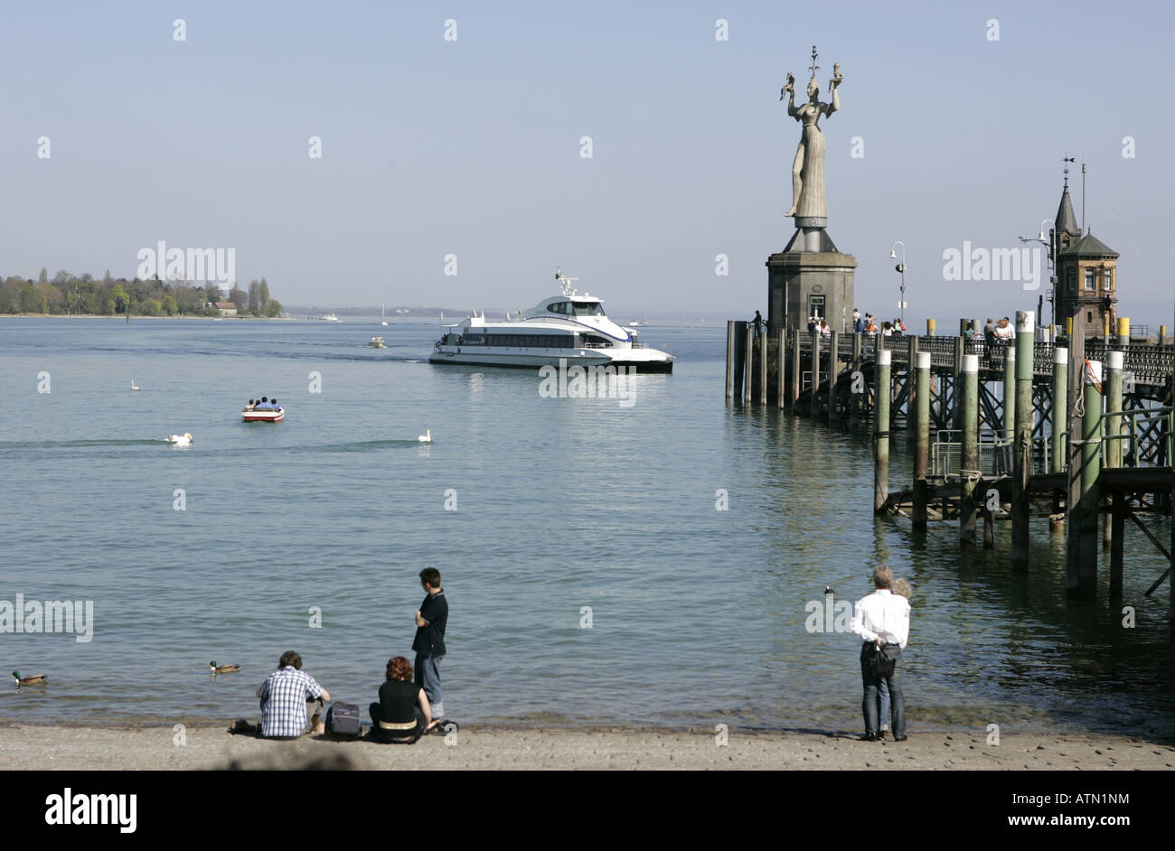 Ferry passing the Imperia sculpture by the artist Peter Lenk on the pier in Constance,Lake Constance,Germany Stock Photo