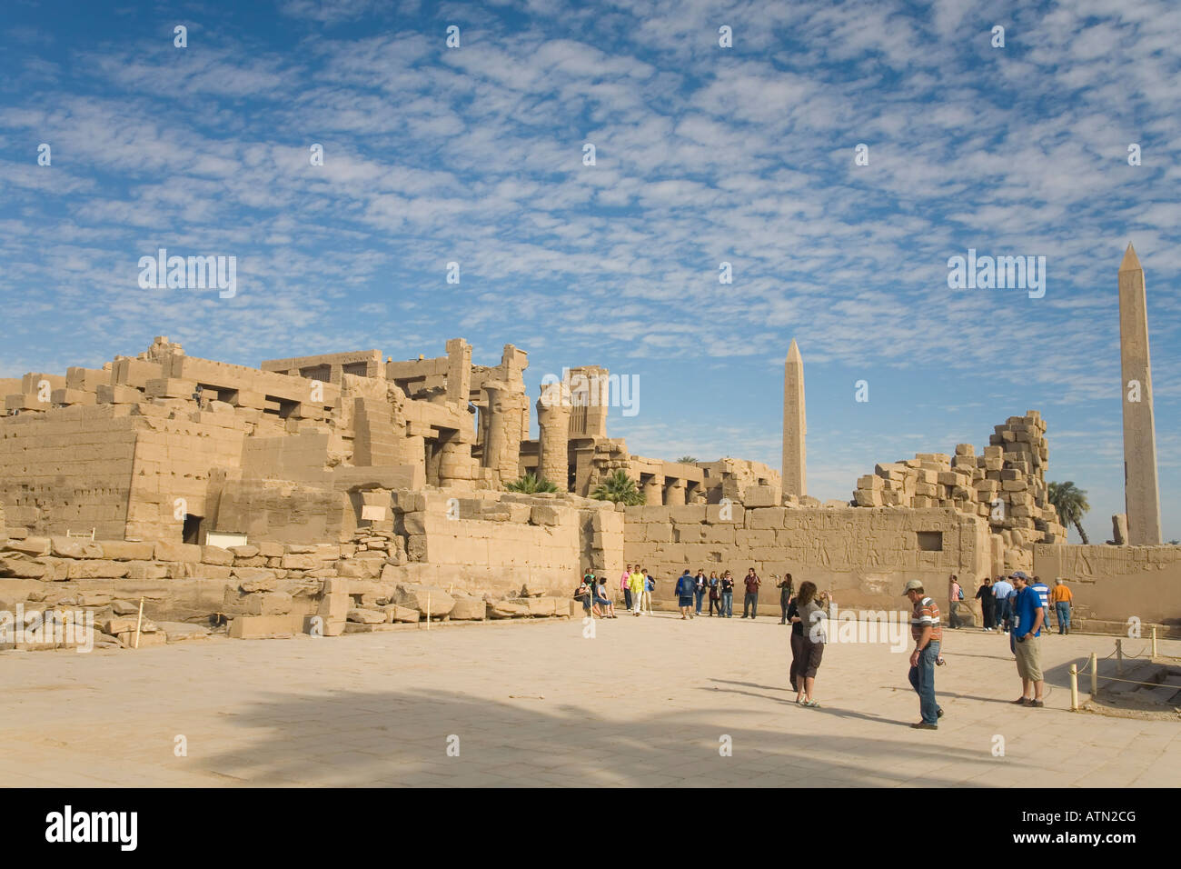 Temple of Amun-Re Amun Re with courtyard obelisks and columns with visitors and tourists Karnak Egypt North Africa Stock Photo