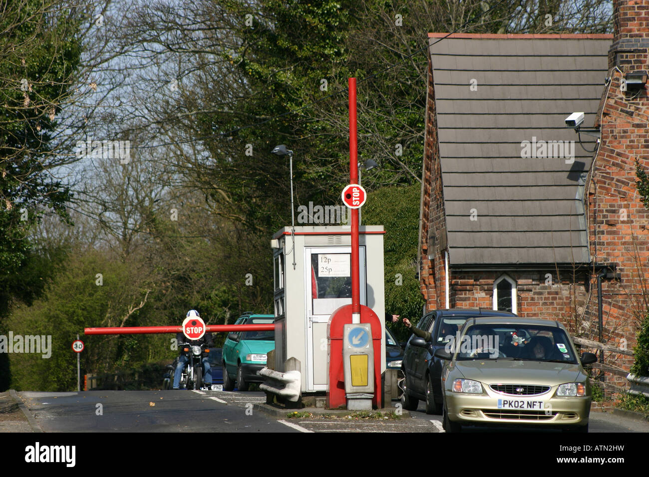 toll bridge booth cottage barrier raised cars Stock Photo - Alamy
