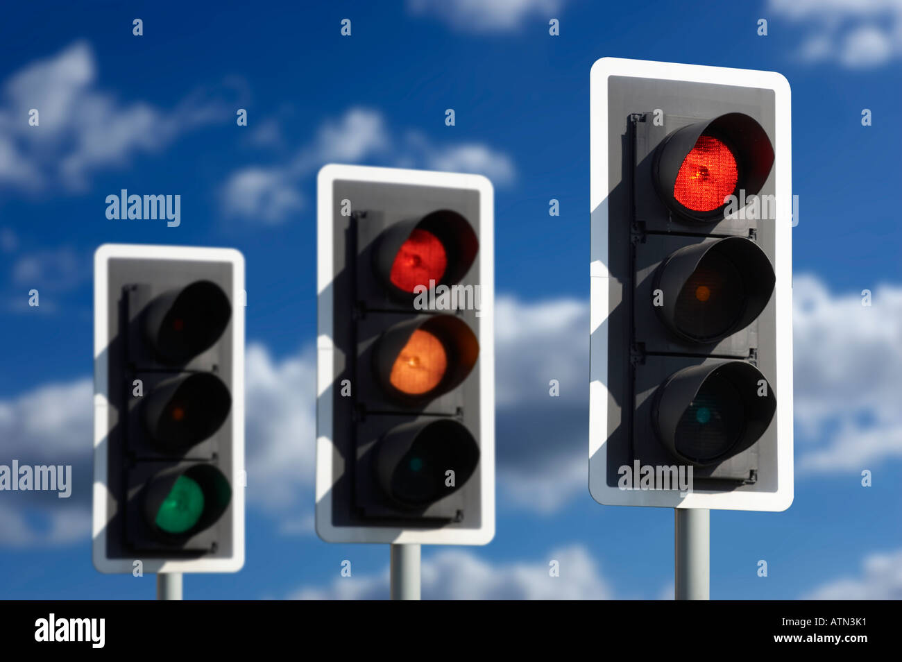 ROW OF THREE ROAD TRAFFIC LIGHTS SHOWING SEQUENCE OF RED AMBER AND GREEN Stock Photo