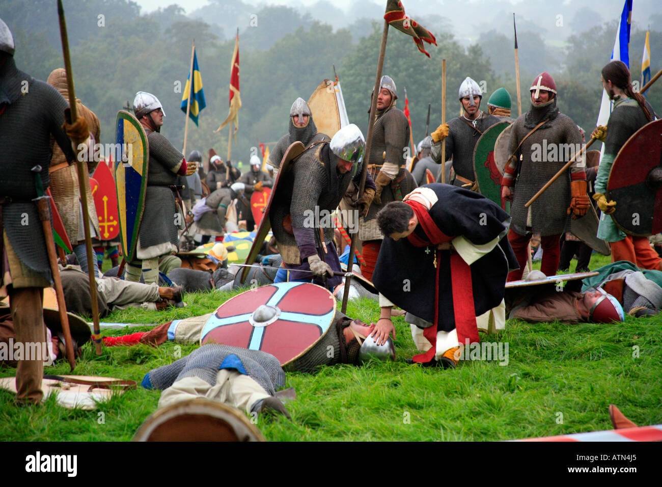 Priest gives Final Rites to fallen soldier 1066 Battle of Hastings England re creation Stock Photo