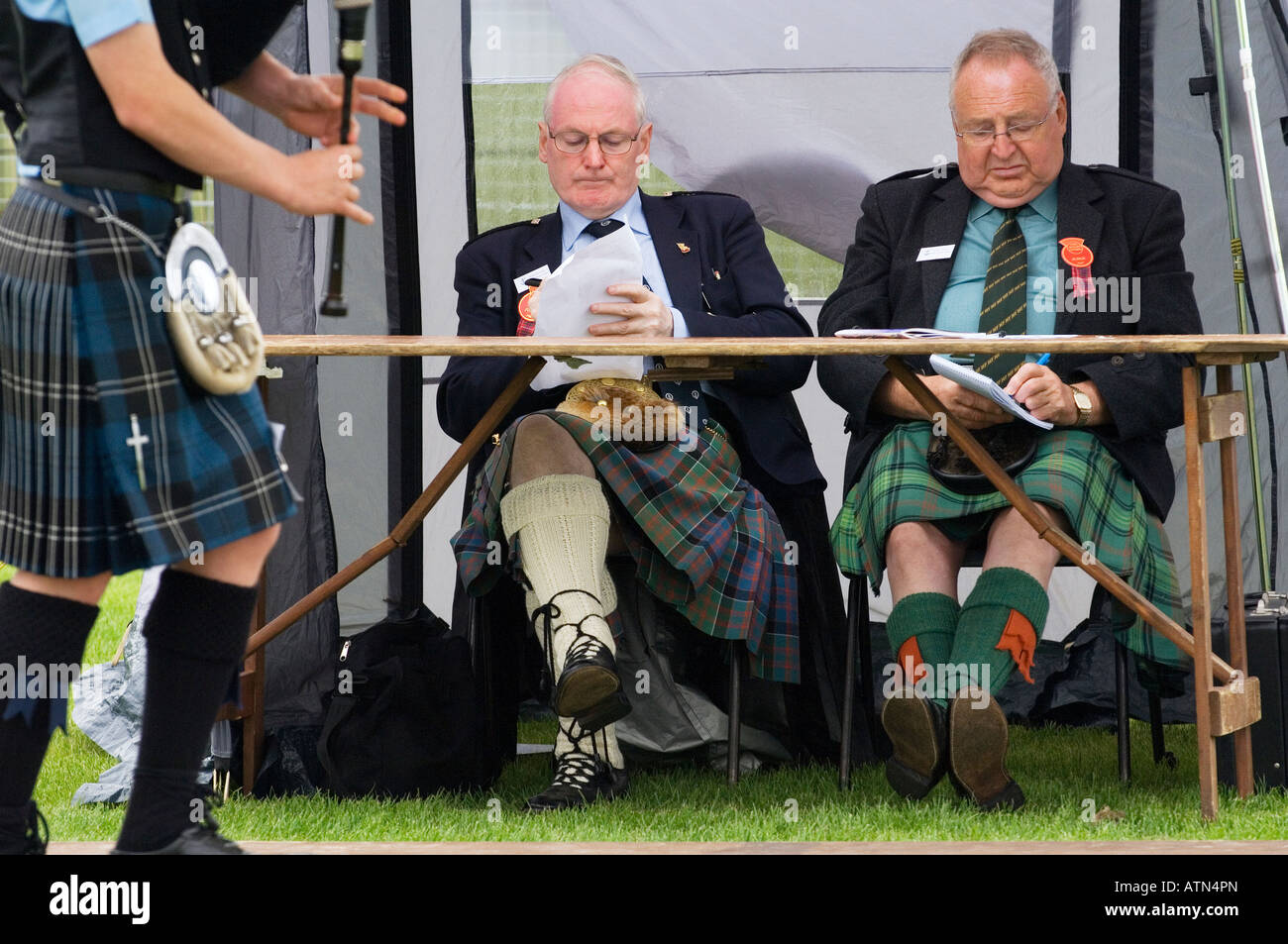 Bagpipe player and piping contest judges at the prestigious annual Cowal Highland Gathering at Dunoon, Strathclyde, Scotland, UK Stock Photo