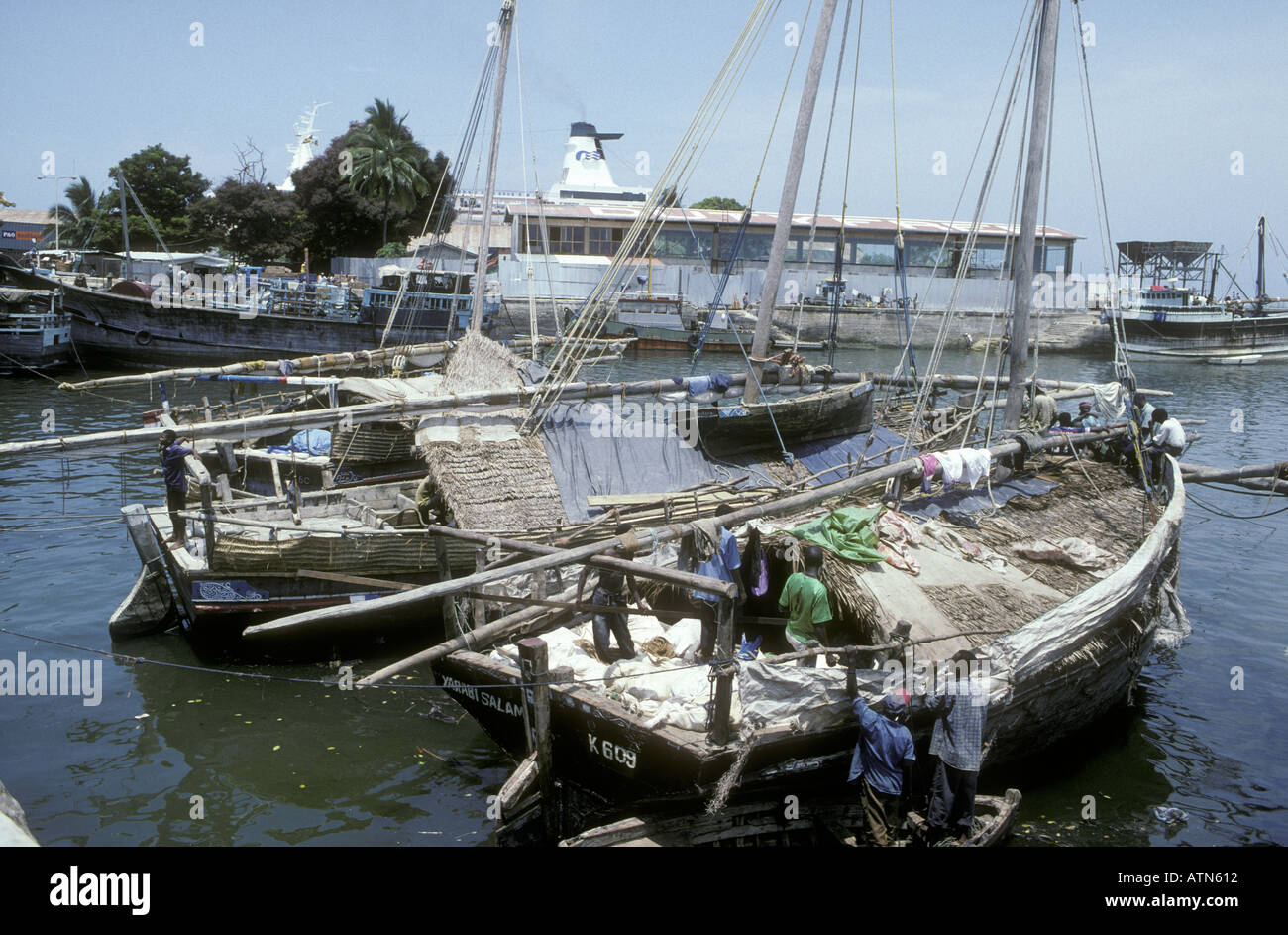 Two dhows or sailing boats loaded up in Zanzibar harbour Tanzania East Africa Stock Photo