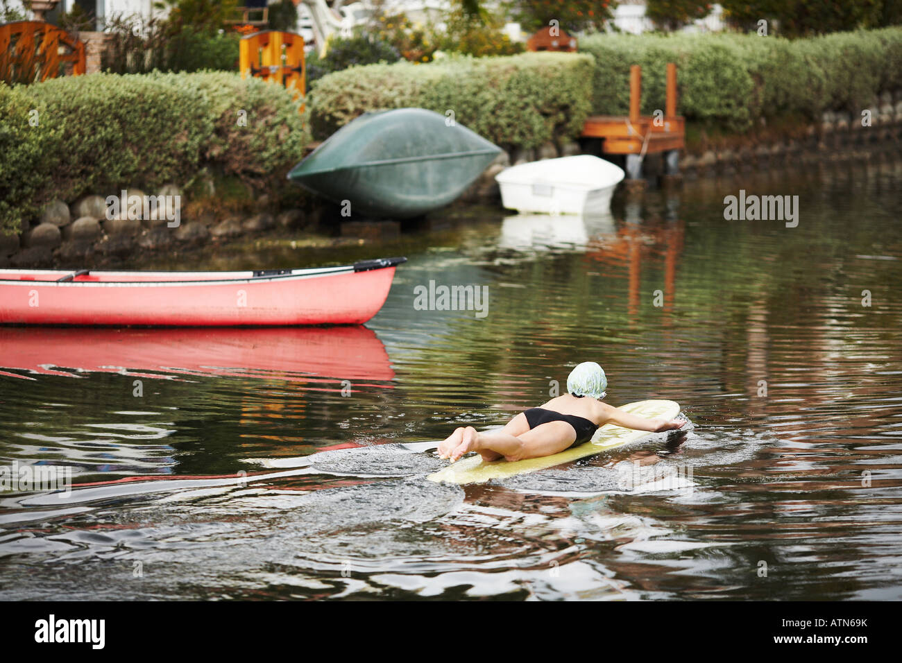 Woman Swimming in Canal in the Venice Beach Canals Area, Los Angeles