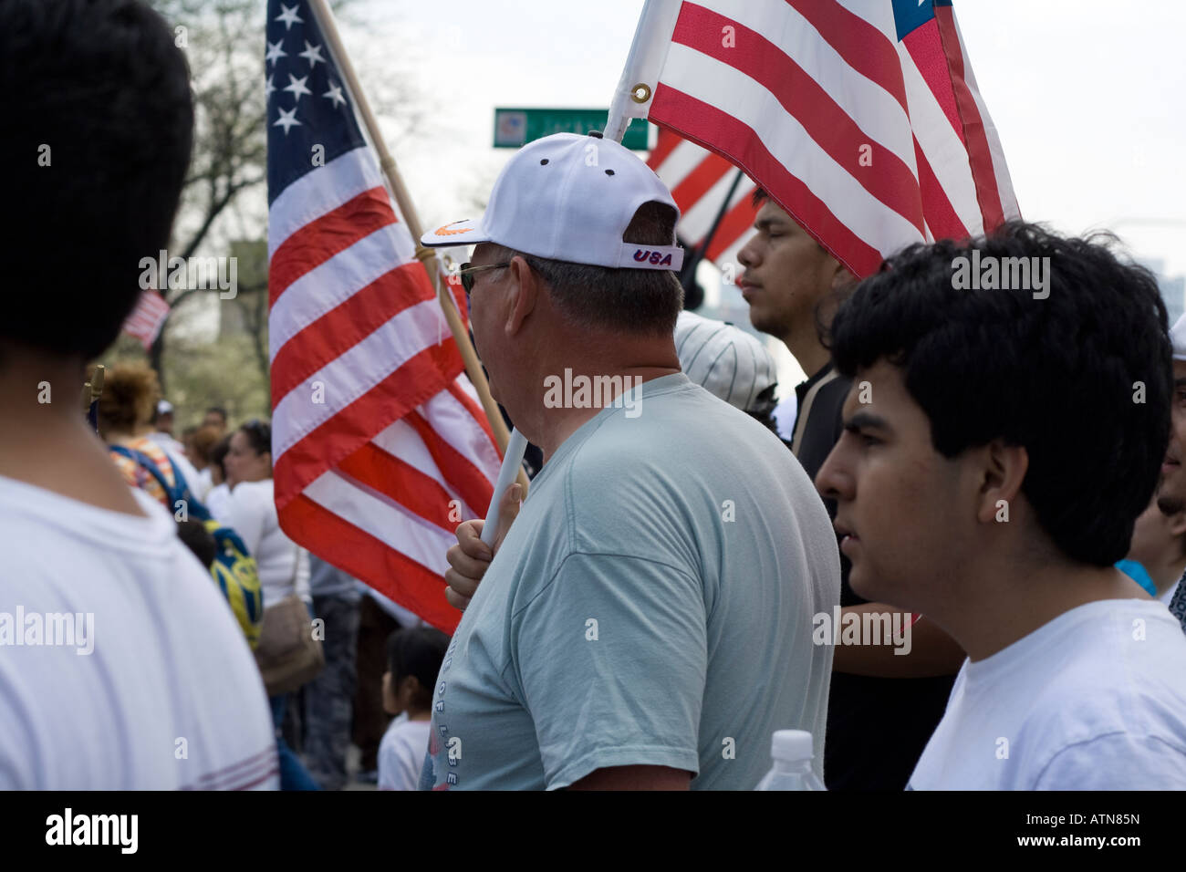 Chicago Illinois immigration rally hispanic men and women carrying american flags Stock Photo