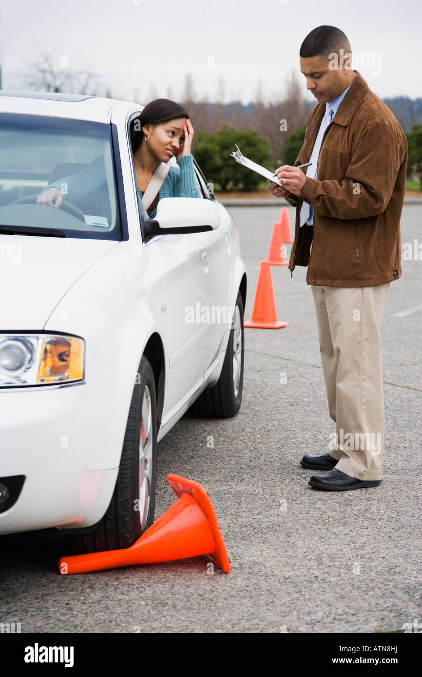 African teenager running over traffic cone at drivers test Stock Photo