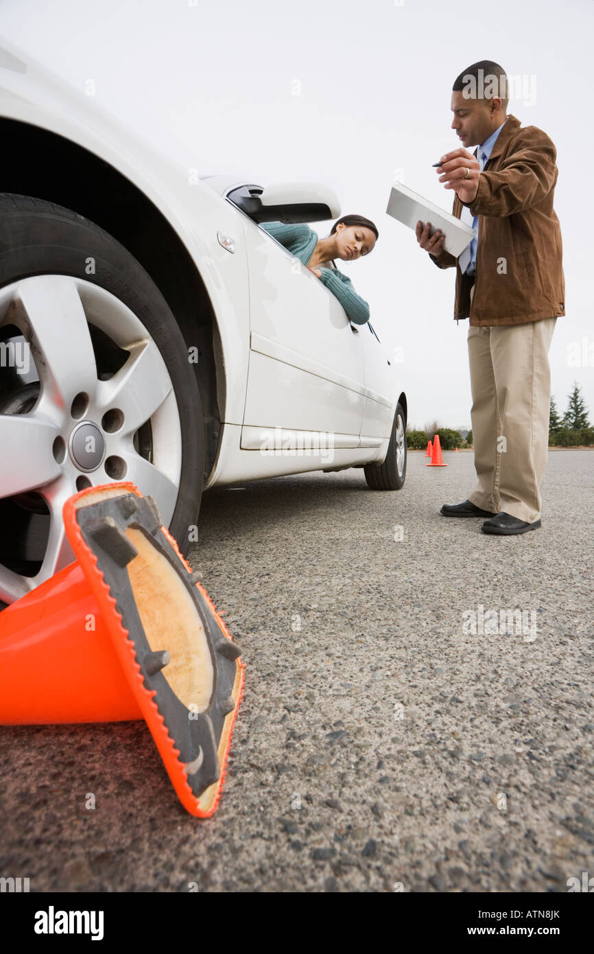 African teenager running over traffic cone at drivers test Stock Photo