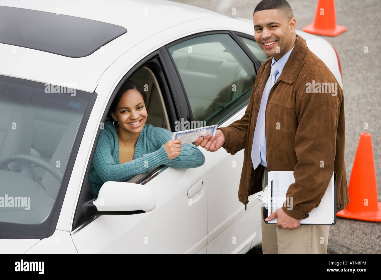 African teenager receiving drivers test certificate Stock Photo