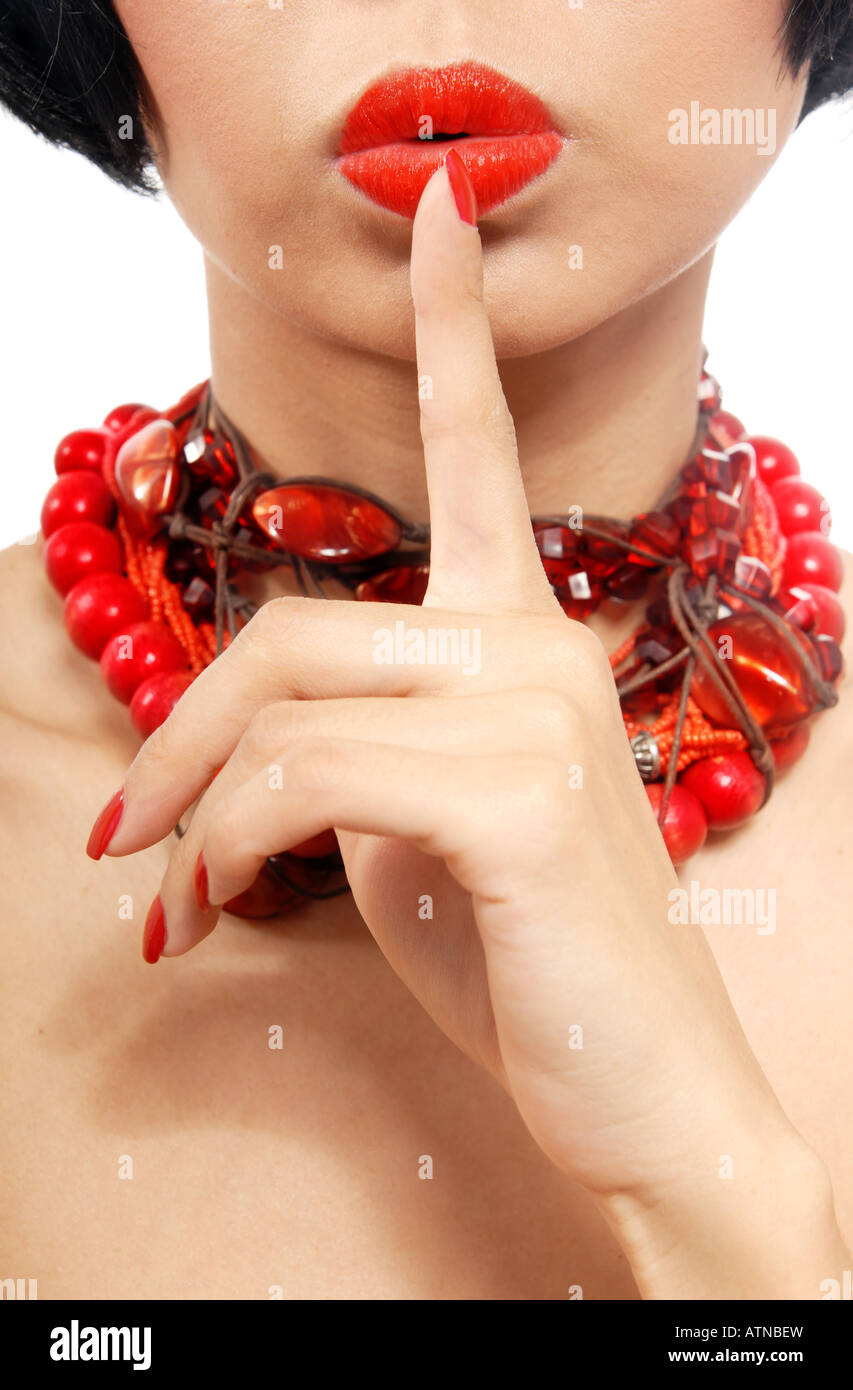 Woman in red chaplet with finger on her lips Stock Photo