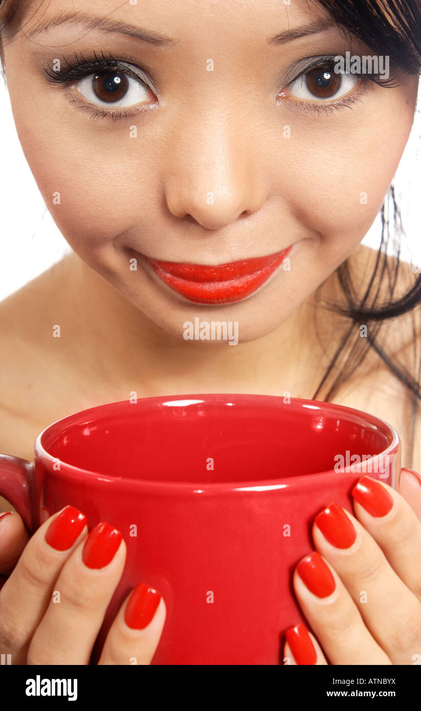 Smiling model holding red cup with drink or eat Stock Photo Alamy