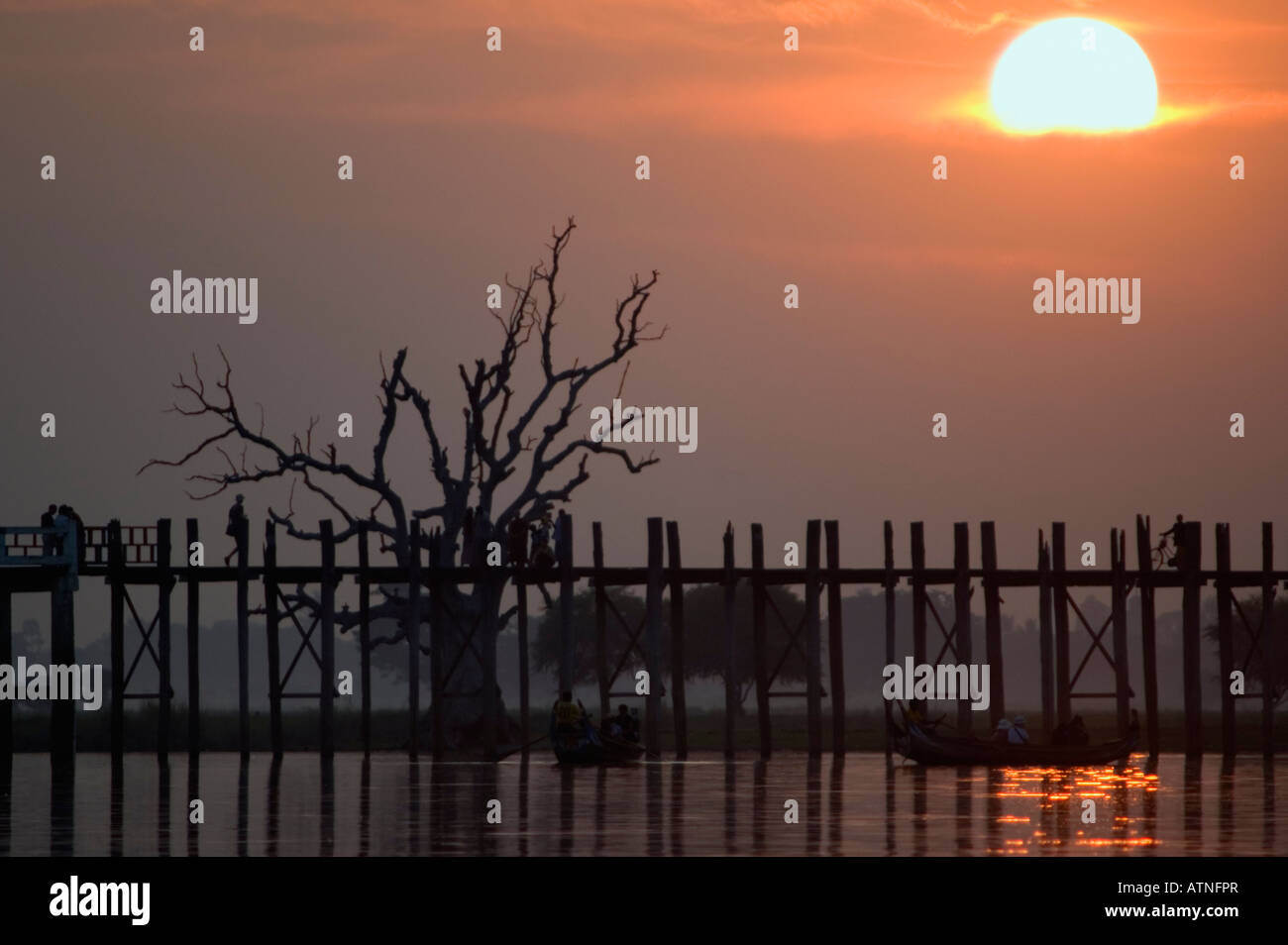 Silhouette of a tree and U Bein s Bridge at sunset Ayeyarwady River ...