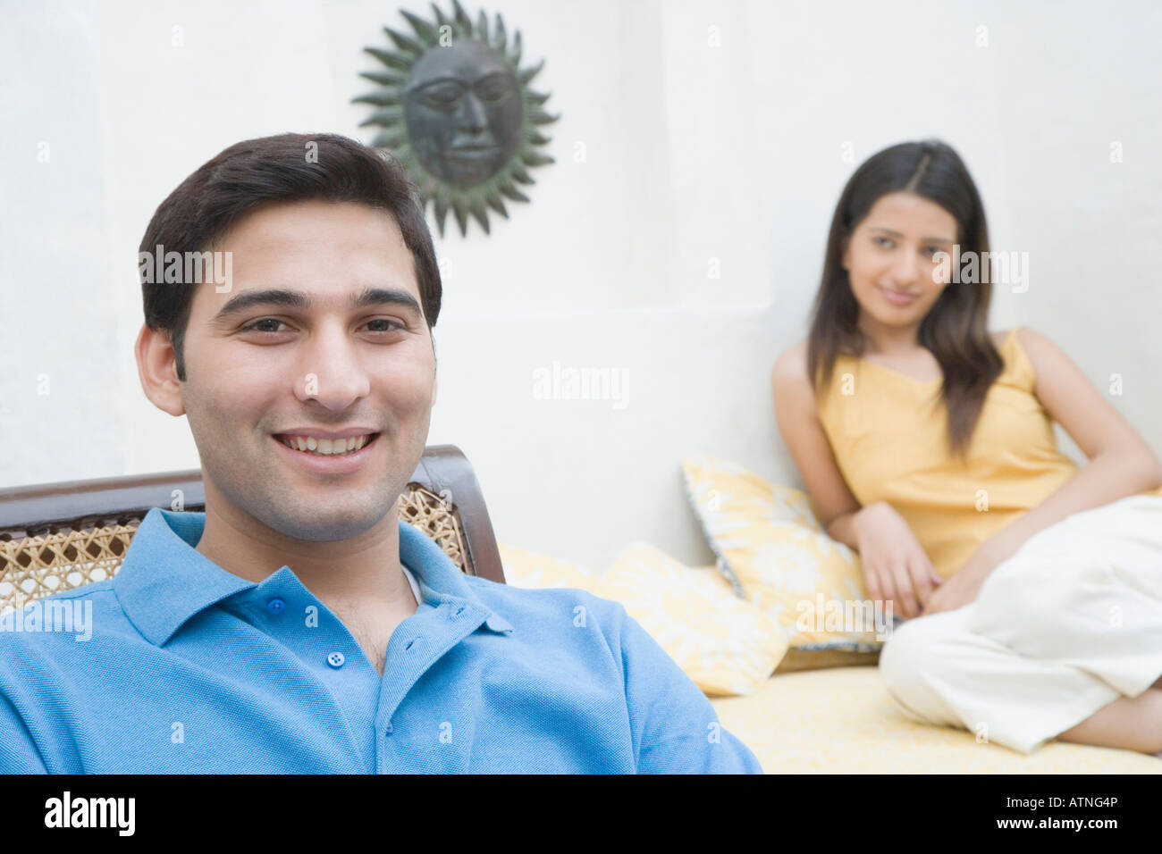 Portrait of a young man smiling with a young woman beside him Stock ...