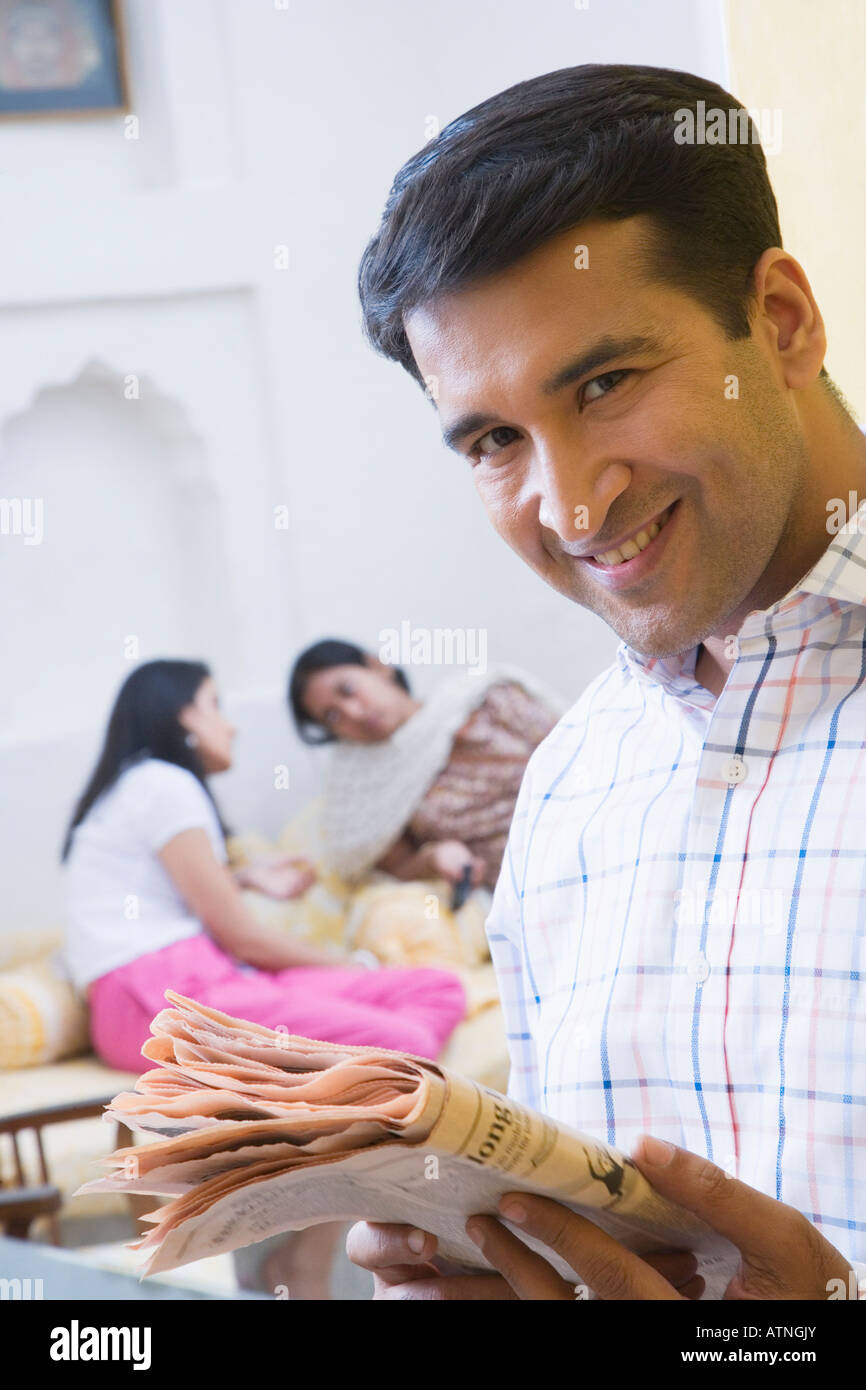 Portrait of a mid adult man smiling with two mid adult women talking in ...