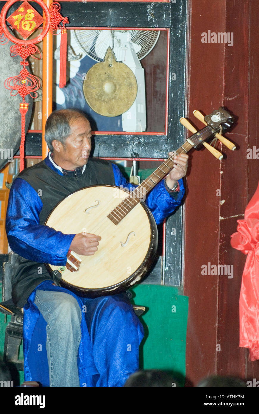 Naxi Orchestra Musician Playing The Ruan, the Chinese Guitar, Lijiang Old Town, Yunnan Province, China Stock Photo