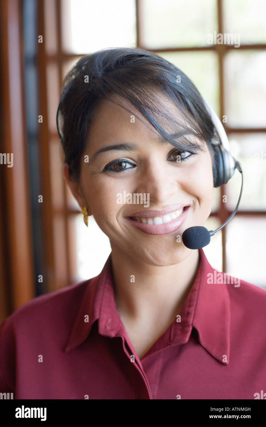 Portrait of a businesswoman wearing a headset and smiling Stock Photo ...