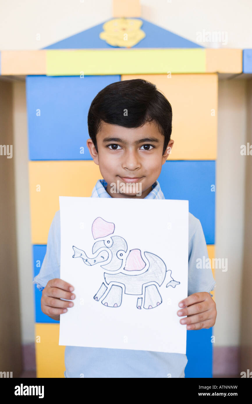Portrait of a schoolboy showing a drawing Stock Photo - Alamy