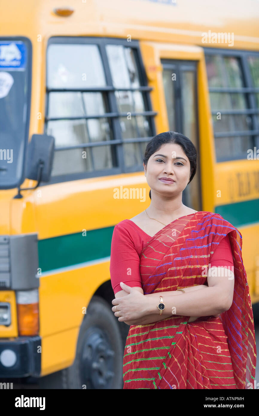 Portrait of a teacher standing near a school bus Stock Photo - Alamy