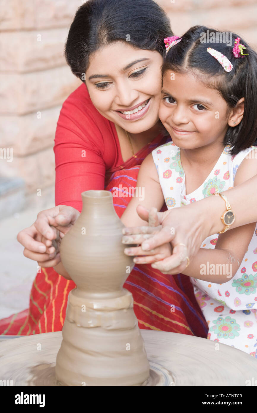 Girl with her teacher in a pottery class Stock Photo - Alamy