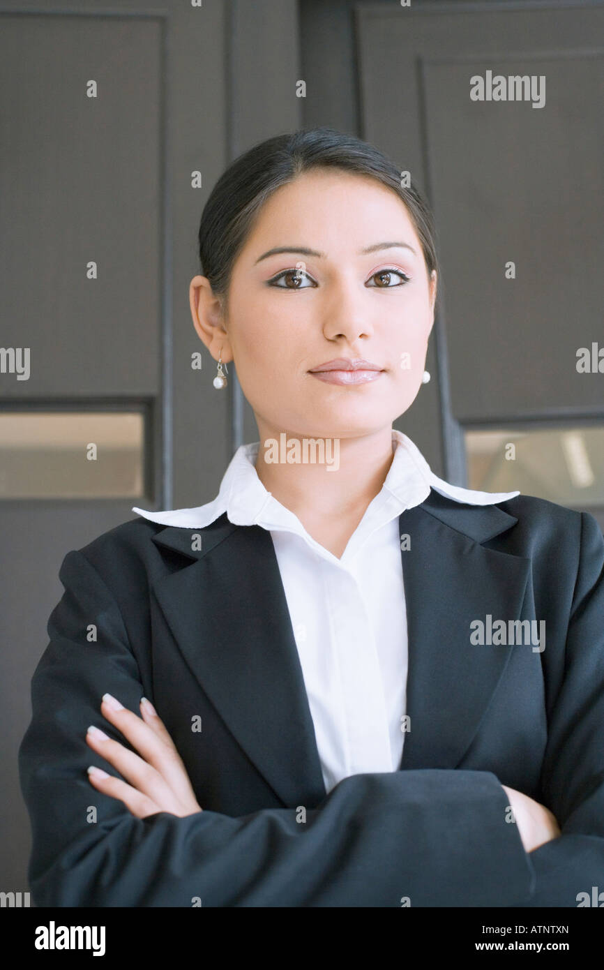 Portrait of a businesswoman standing with her arms crossed Stock Photo ...