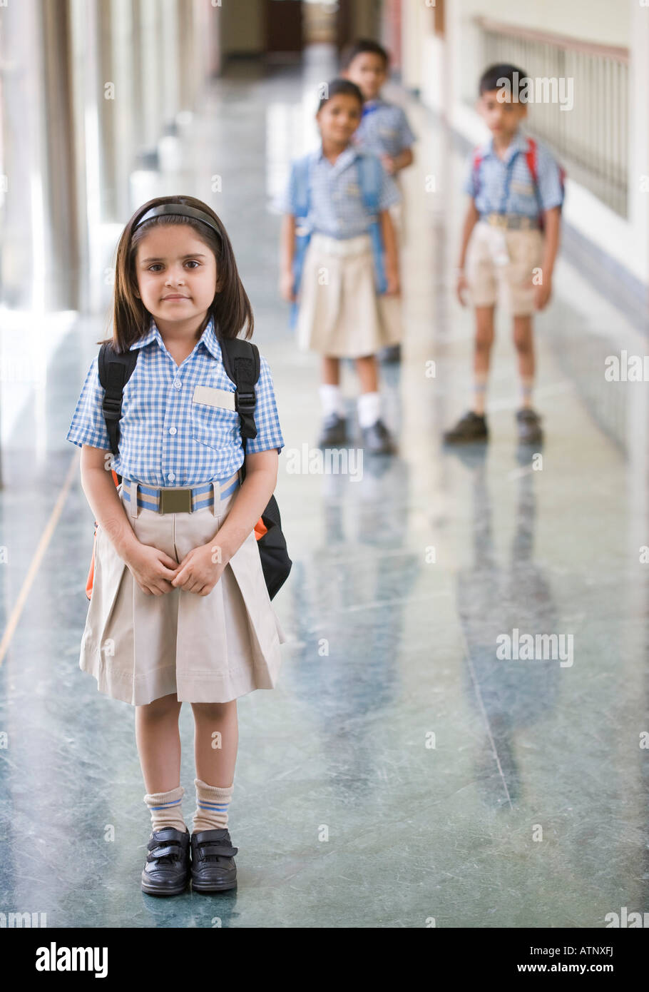 Portrait of a schoolgirl standing in the corridor of a school Stock ...