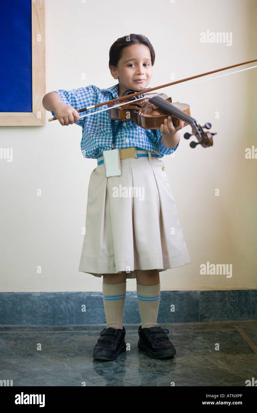 Portrait of a schoolgirl playing a violin in a music class Stock Photo