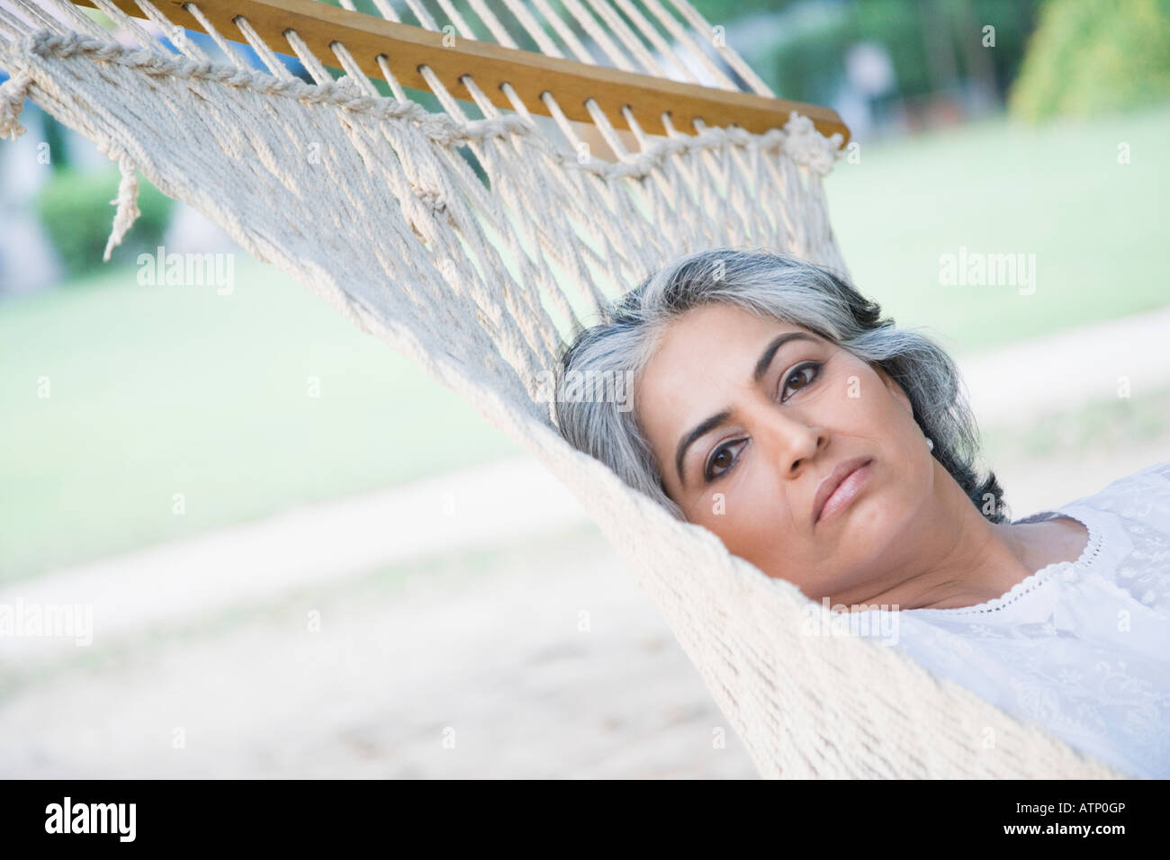Portrait of a mature woman lying in a hammock Stock Photo - Alamy