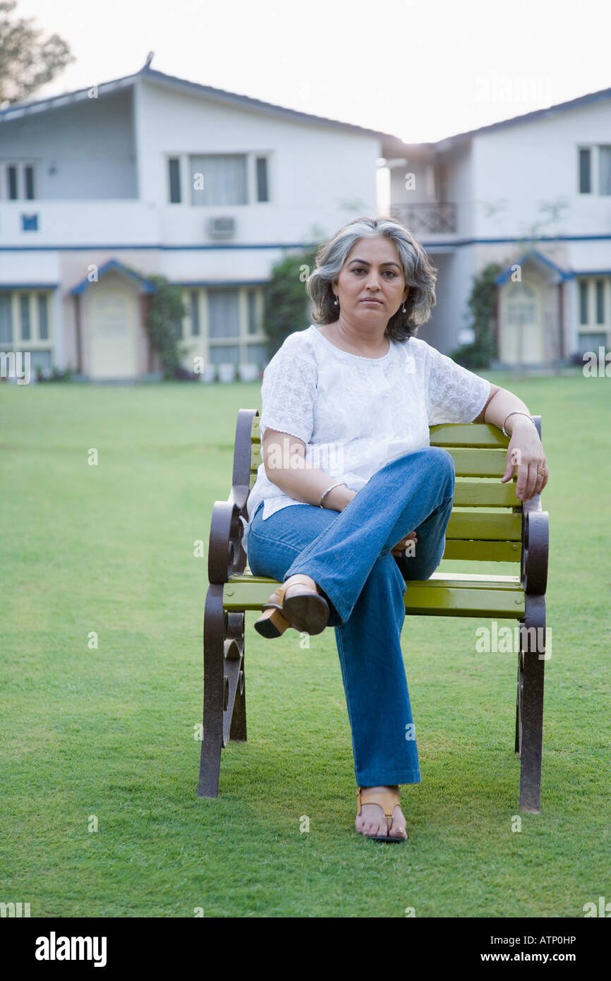 Portrait of a mature woman sitting on the bench Stock Photo - Alamy