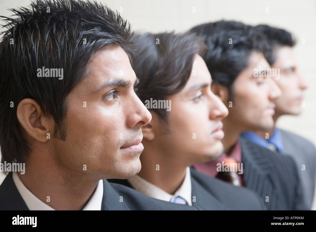 Four businessmen in a row Stock Photo - Alamy