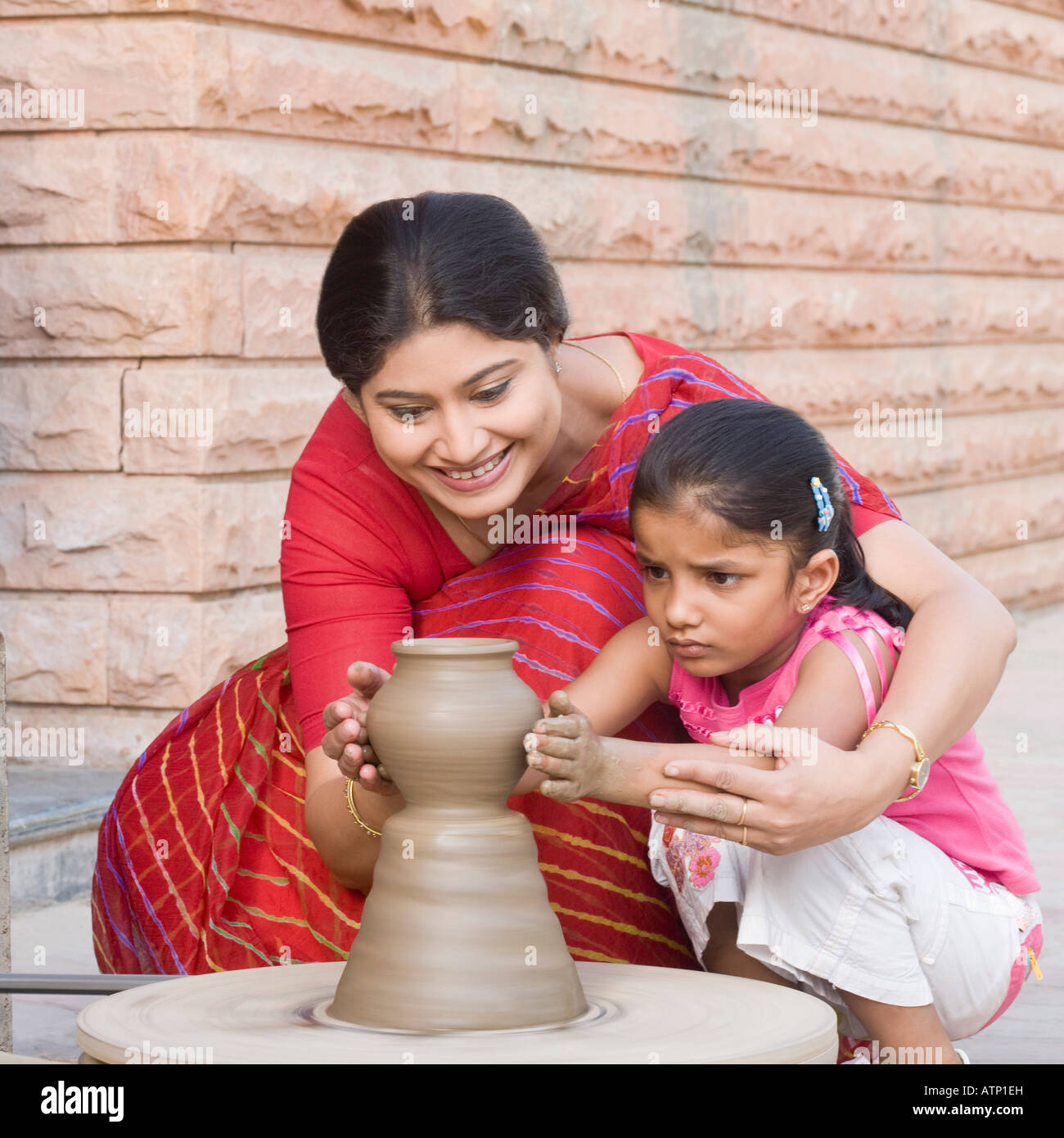 Girl with her teacher in a pottery class Stock Photo - Alamy