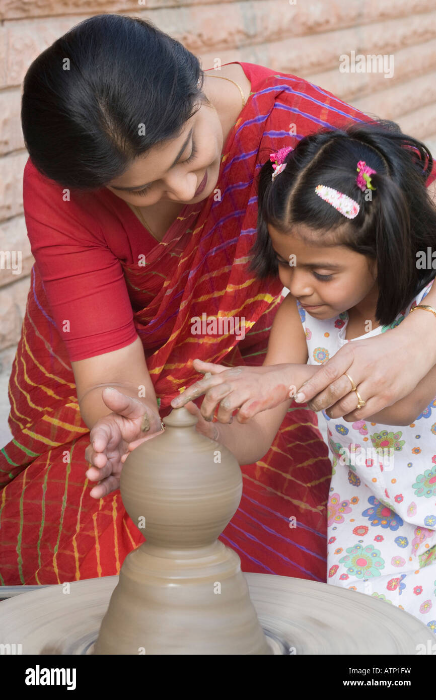 Girl with her teacher in a pottery class Stock Photo - Alamy