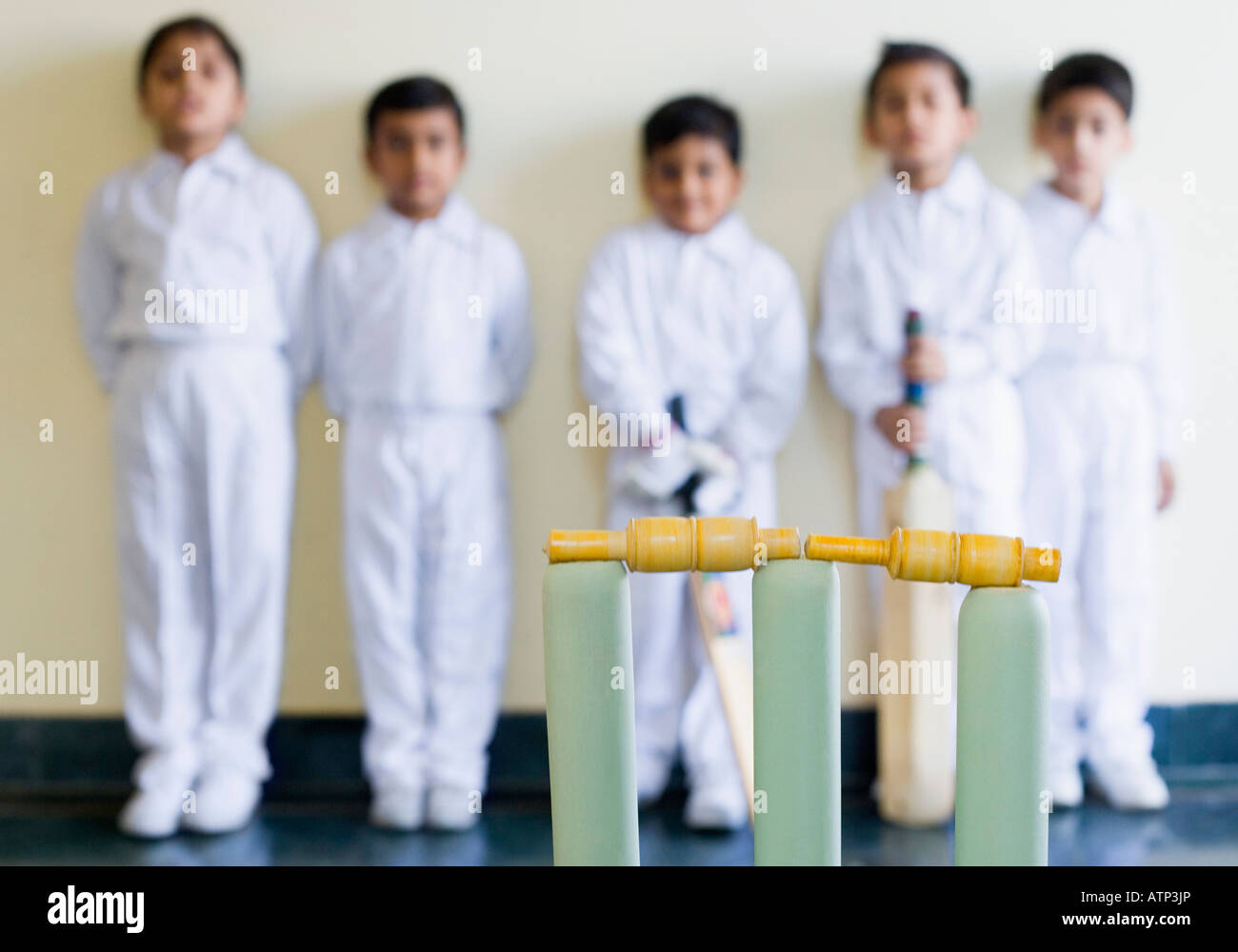 Close-up of cricket stump with cricket players standing in the background Stock Photo