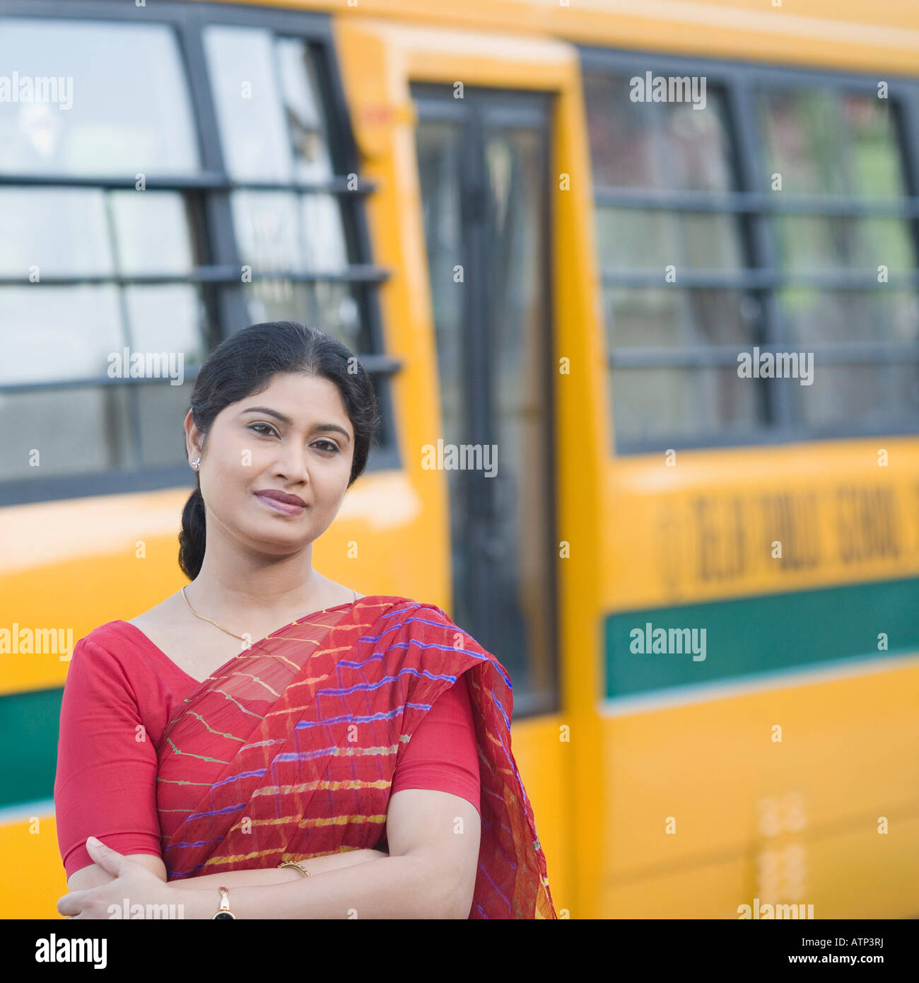 Portrait of a teacher standing near a school bus Stock Photo - Alamy