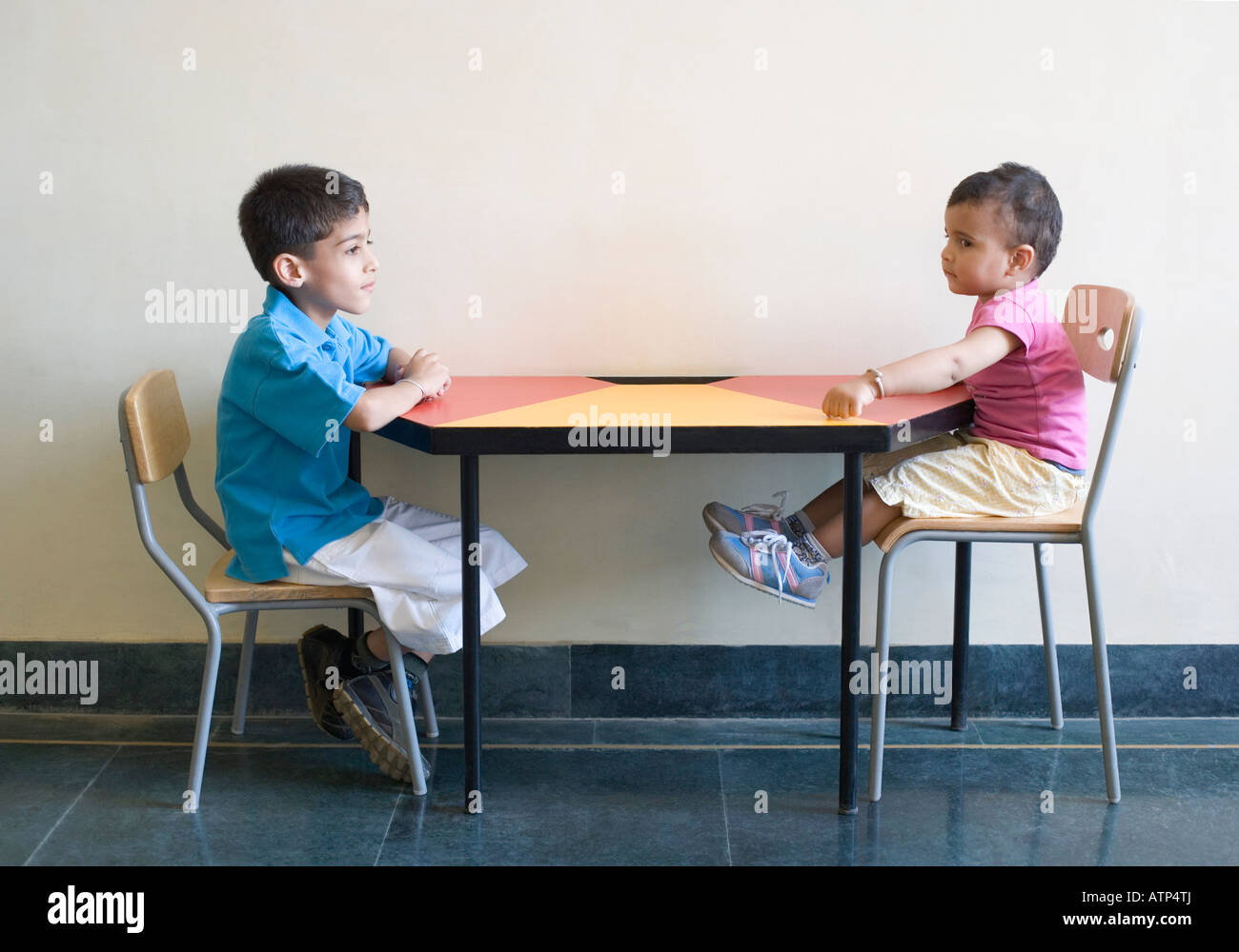 Side profile of two boys sitting at a table Stock Photo 16365281 Alamy