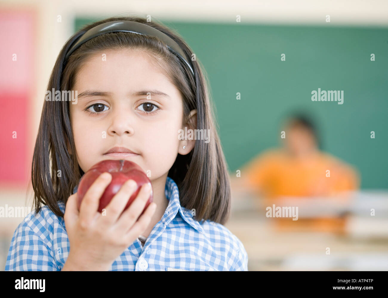 Portrait of a schoolgirl holding an apple Stock Photo - Alamy