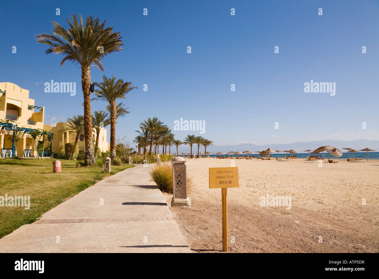 Taba Heights Sinai Peninsula Egypt Jogging track and waterfront promenade by quiet beach in resort on Red Sea east coast Stock Photo