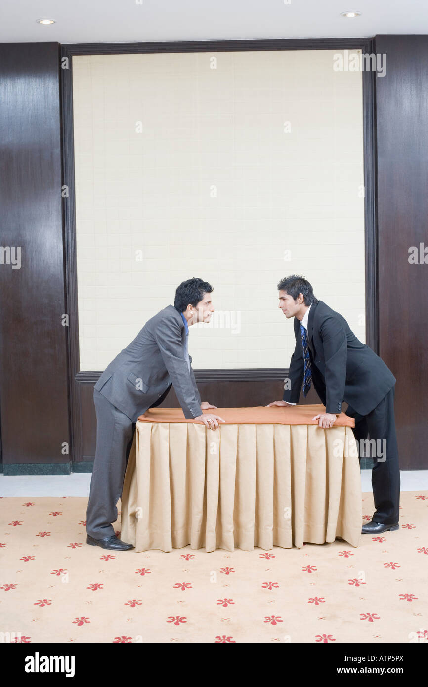 Side profile of two businessmen looking at each other Stock Photo - Alamy
