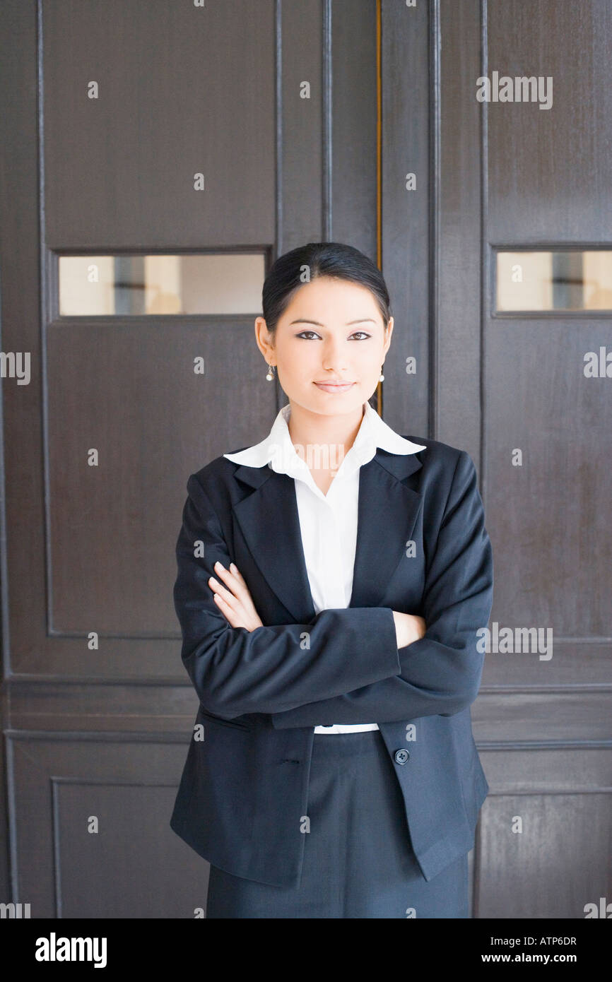 Portrait of a businesswoman standing with her arms crossed Stock Photo ...