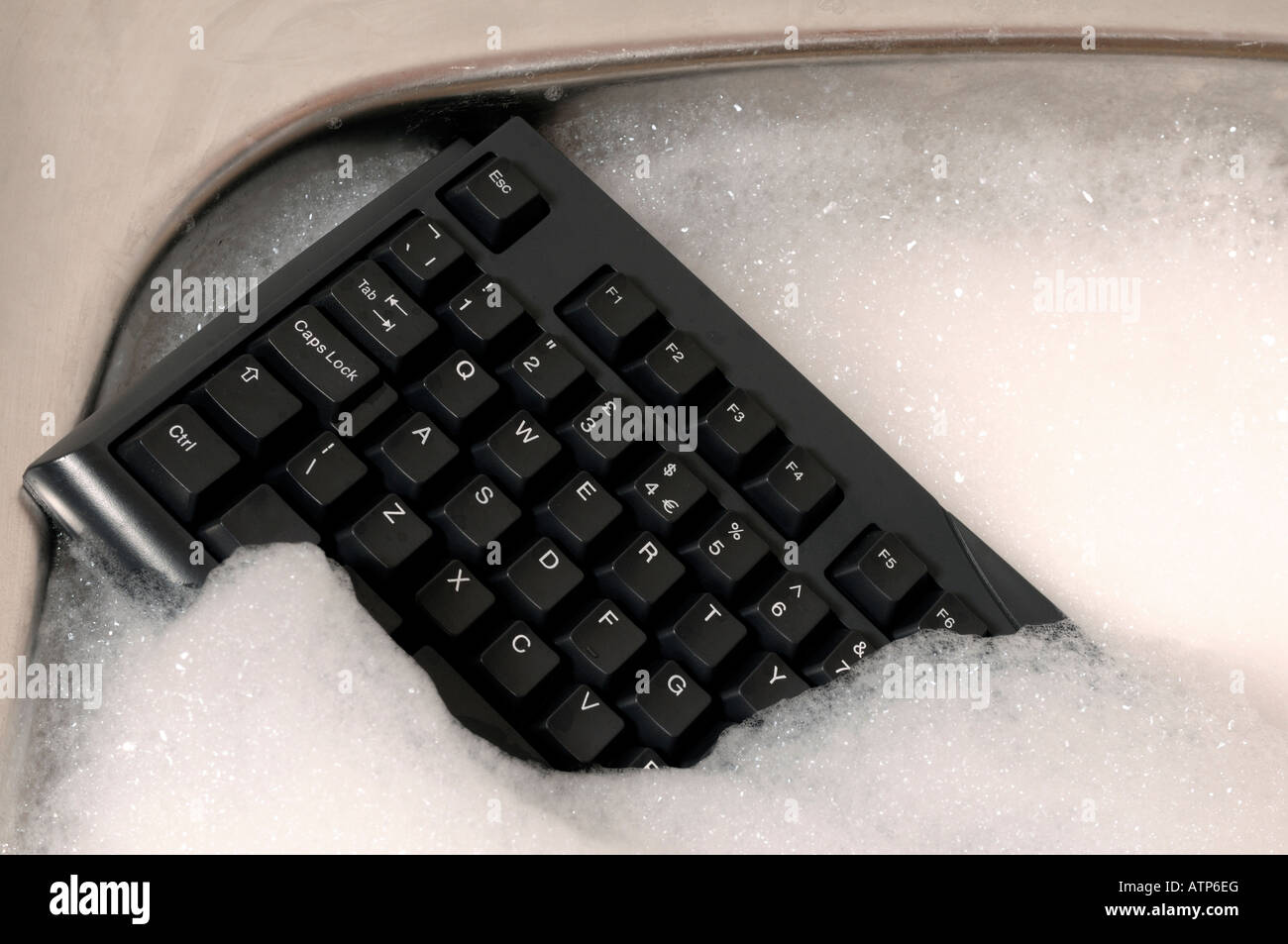 Computer keyboard in a kitchen sink Stock Photo Alamy