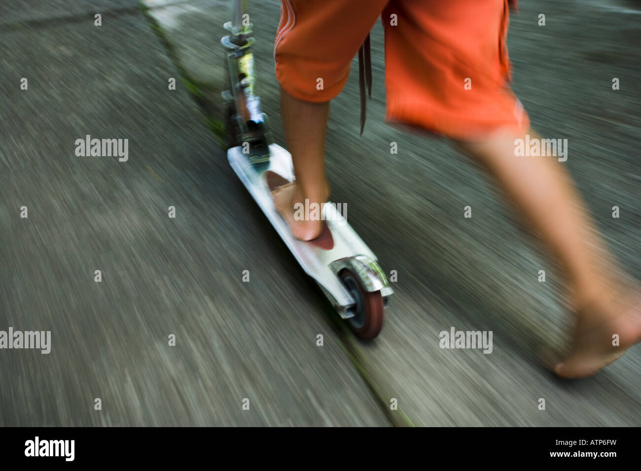 Boy rides modern scooter Stock Photo